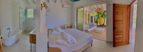 two pictures of a bathroom with a bed and a tub at Villa Cokoon in Saint-François