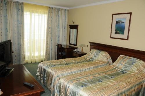 Postel nebo postele na pokoji v ubytování Hotel Granit