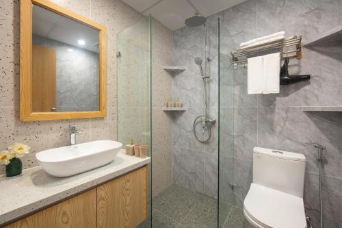 a bathroom with a sink and a toilet and a shower at Westlake Pearl Apartment - Hotel & Pearl Spa in Hanoi