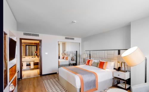 a hotel room with a large bed and a bathroom at Mercure Alger Palais Des Congres in Alger