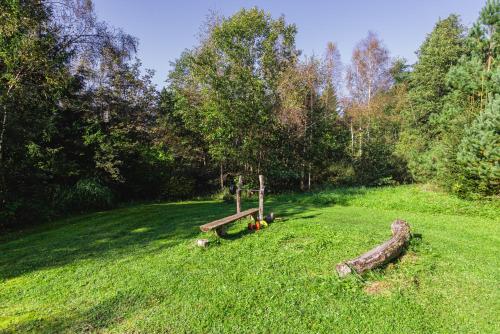 a park with a bench in the middle of a field at Pirties namas by Stay Lagom in Stirbaičiai