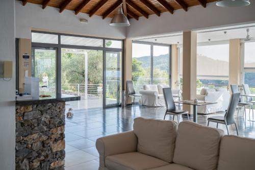 a living room with a couch and a table and chairs at La Luna Hotel in Troulos