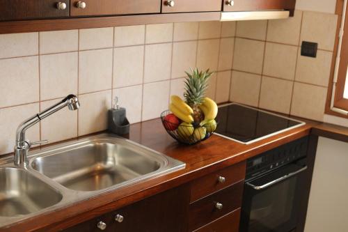 a kitchen with a sink and a bowl of bananas at Ontas Traditional Apartment In Gavalochori - BY APOKORONAS VILLAS in Gavalochori