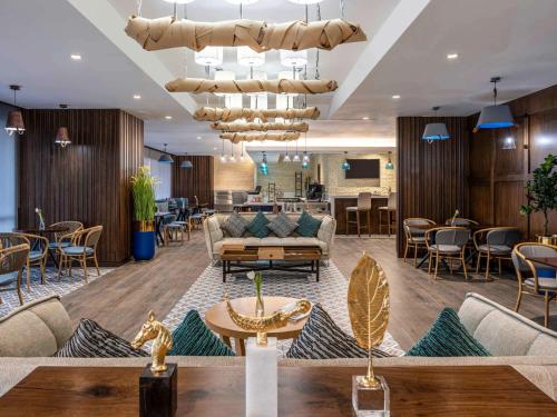 a lobby of a hotel with a couch and a table at Novotel Makkah Thakher City in Makkah