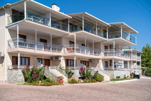 a large white building with balconies and flowers at La Luna Hotel in Troulos