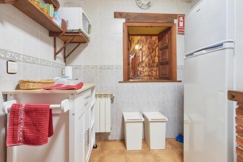 a kitchen with a counter and two stools at Aldaron in Boca de Huérgano