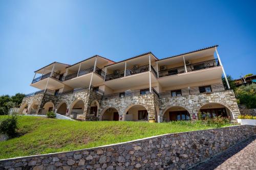 an apartment building with balconies on a hill at La Luna Hotel in Troulos