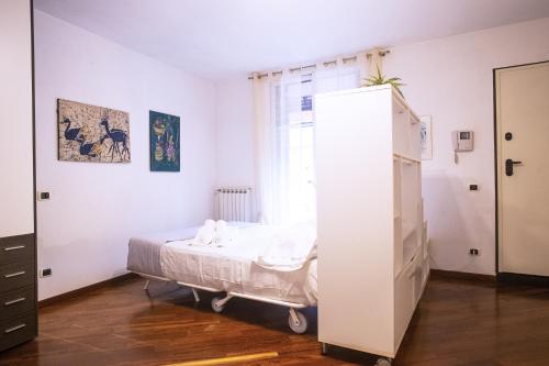 a bedroom with a bed and a large white cabinet at Cà di Rosa in Sestri Levante