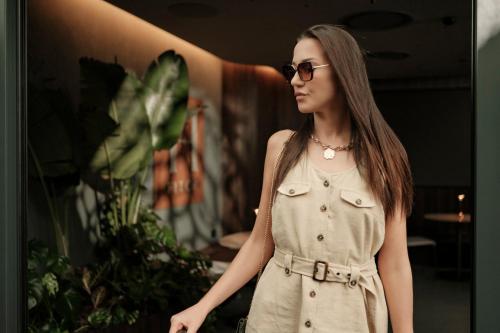 a young woman wearing a dress and sunglasses at Fitch Hotel in St Julian's