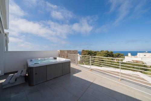 a hot tub on a balcony with a view of the ocean at Penthouse Venere su 2 piani - Leuca by Salento Pri in Leuca