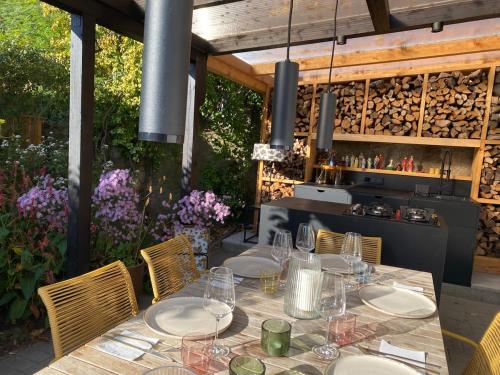 a table with plates and wine glasses on a patio at Sommerhaus am Trebuser See in Fürstenwalde