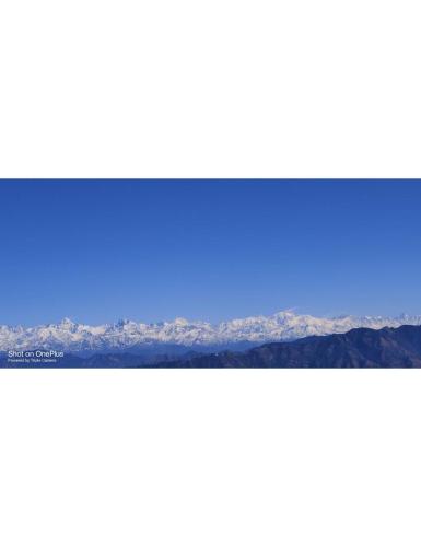 a view of the mountains from the horizon at The Royals Apricot Garden, Chamba in Dhanaulti