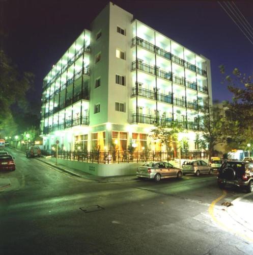 a large building with cars parked in front of it at Arte Annapolis Inn in Rhodes Town