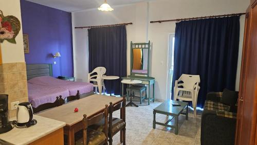 a bedroom with a bed and a table and chairs at Arte Annapolis Inn in Rhodes Town