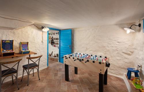 a room with a foosball table and chairs at Beautiful Villa Palazzo Adriana Krk in Dobrinj