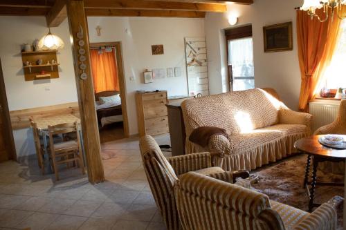 a living room with a couch and a table at Pogácsás Porta in Kiskorpád