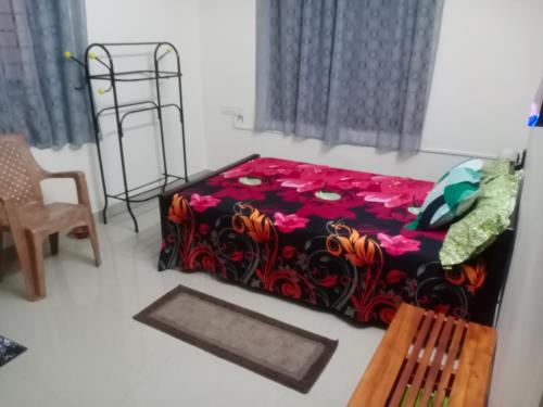 a bedroom with a bed and a chair at Little Mount nest in Trivandrum