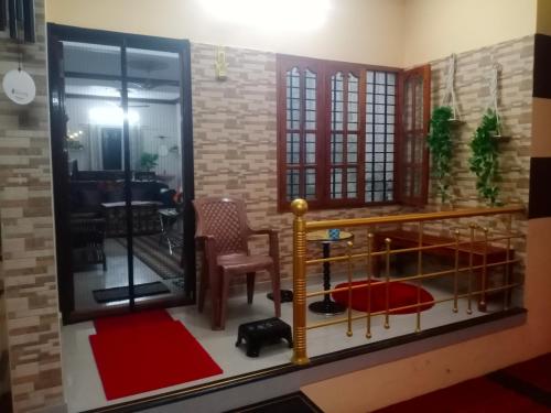 a living room with a table and a chair at Little Mount nest in Trivandrum