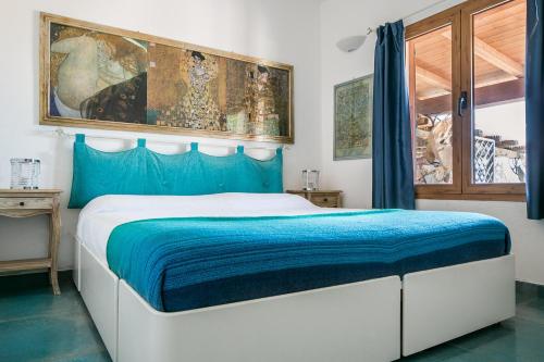 a bedroom with a large bed with a blue blanket at Casa Azul, Seaview terrace, private parking, pool in Marinella