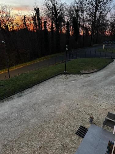 a parking lot with a bench in a park at Studio24 in Trélissac
