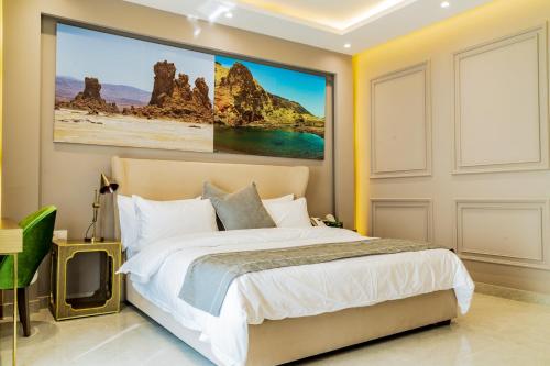 a bedroom with a bed and a large painting on the wall at The Villa Haramous in Djibouti
