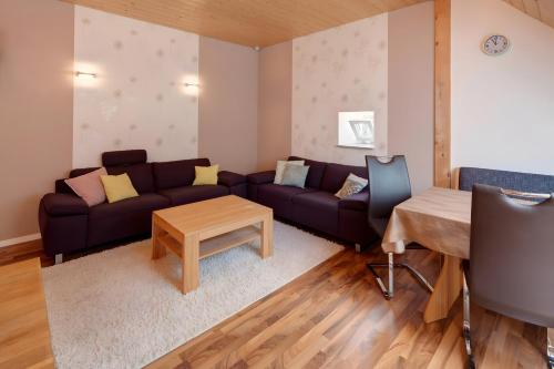 a living room with a couch and a table at Hof in L i e b e s d o r f - Akelei in Gerabronn