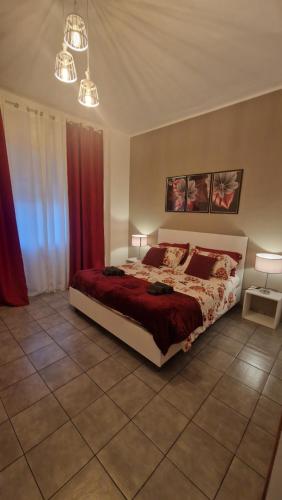 a bedroom with a bed and red curtains at CinqueStanze in Cosenza