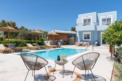 a villa with a swimming pool and a house at Ethria Pool Villa with heated jacuzzi in Afantou