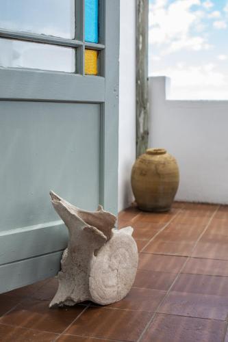a rock sitting on the floor next to a door at Die Pomphuisie in Paternoster