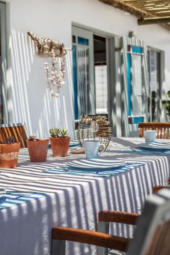a table with a blue and white table cloth on it at Die Pomphuisie in Paternoster