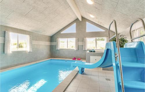 a swimming pool with a blue slide in a house at Awesome Home In Grenaa With Sauna in Grenå
