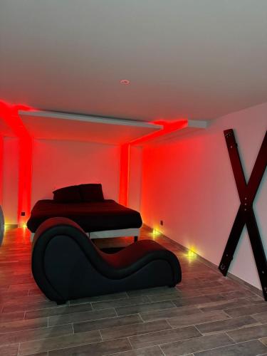 a bedroom with two beds in a room with red lights at L'écrin in Bourges