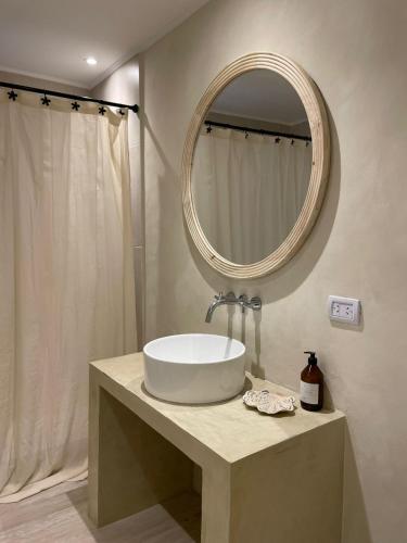 a bathroom with a sink and a mirror at Senderos del Mar in Monte Hermoso