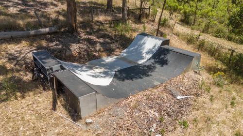 a skateboard ramp sitting in the middle of a field at Funday Farm Adelaide Hills in Norton Summit