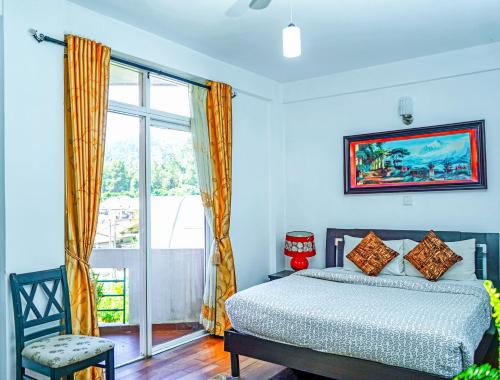a bedroom with a bed and a window at Mountain Breeze Chill Apartment in Nuwara Eliya