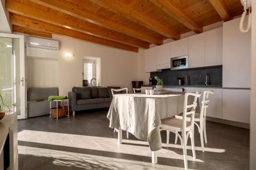 a kitchen and living room with a table and chairs at Delfina Home giardino 013239-CNI-00130 in Vercana