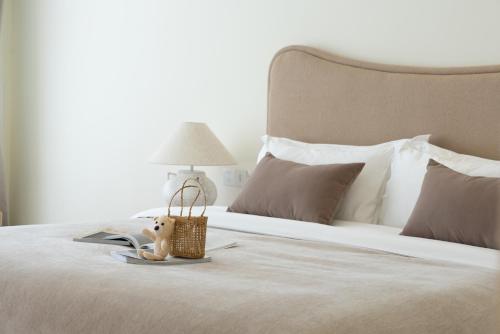 a bed with a book and a stuffed animal on it at 礼橖LoveTime·美学海景民宿（较场尾大鹏所城店） in Shenzhen