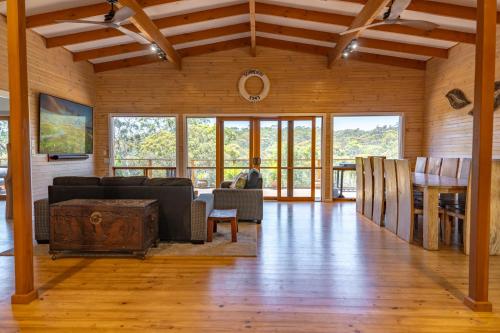 a living room with a couch and a table at Funday Farm Adelaide Hills in Norton Summit