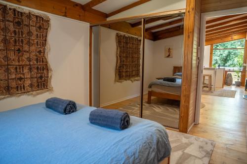 a bedroom with a blue bed in a room at Funday Farm Adelaide Hills in Norton Summit