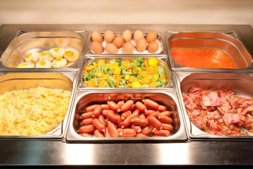 a tray filled with different types of food at Akcent hotel in Prague