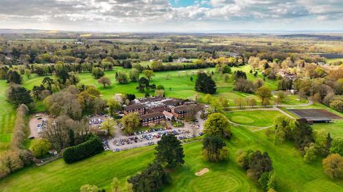 an aerial view of a building in a park at Meon Valley Hotel, Golf & Country Club in Shedfield