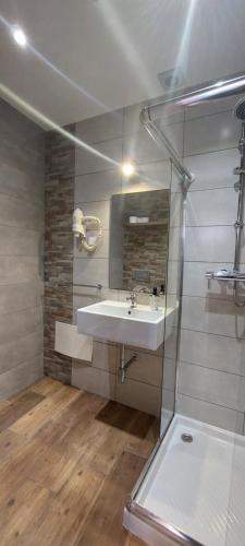 a bathroom with a sink and a mirror at Lagos Downtown Guesthouse in Lagos