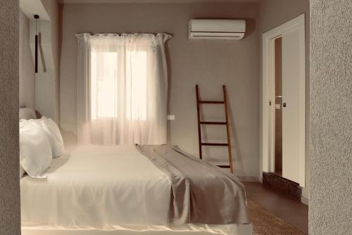 a bedroom with a white bed and a window at Palermo Inn Boutique Hotel in Palermo