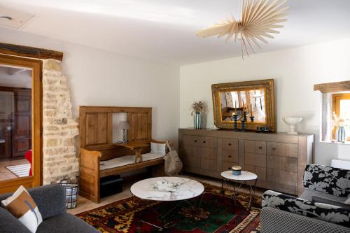 a living room with a couch and a table at Les Prés d'Allerey in Allerey-sur-Saone
