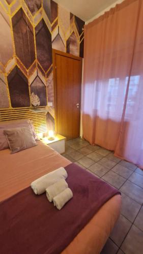 a bedroom with a bed with two towels on it at CinqueStanze in Cosenza
