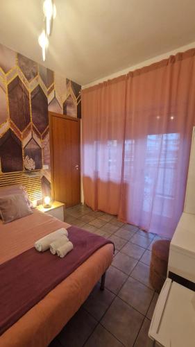 a bedroom with a bed with two towels on it at CinqueStanze in Cosenza
