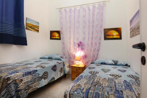 Postel nebo postele na pokoji v ubytování A due passi dal mare by Salento Prime