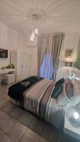 a bedroom with a bed with a window and a desk at CinqueStanze in Cosenza