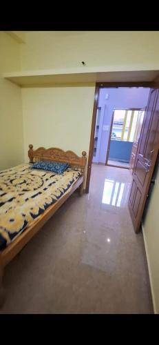 a bedroom with a bed in a room with a door at Subramanya Residency in Thiruchendur
