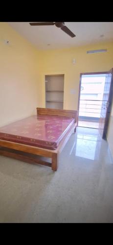 a bedroom with a large bed in a room at Subramanya Inn in Tiruchchendūr
